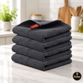 Lot de 4 torchons gaufrés gris Cuizy Towel pliés sur plan de travail